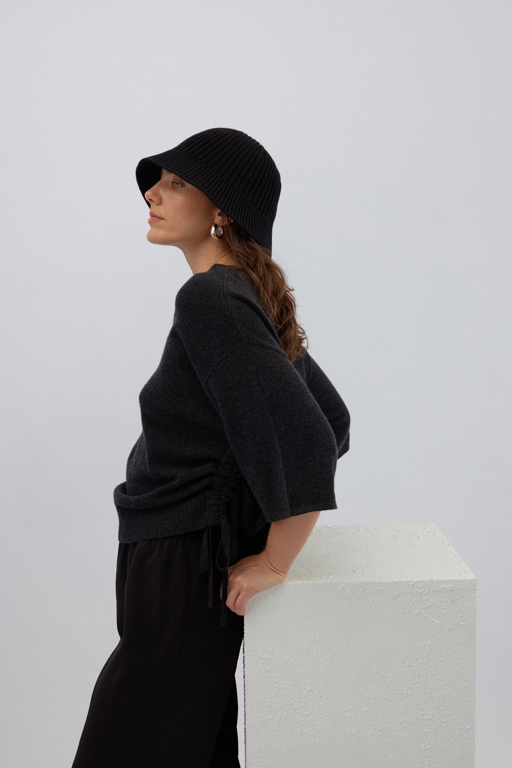 Close up charcoal pure cashmere knit texture adjustable drawstring detail luxury sweater